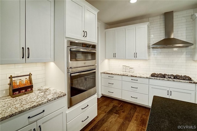 2500 Madison Station Ct, Henrico, VA 23233 - kitchen featuring wall chimney exhaust hood, stainless steel appliances, backsplash, dark wood-style floors, and white cabinetry