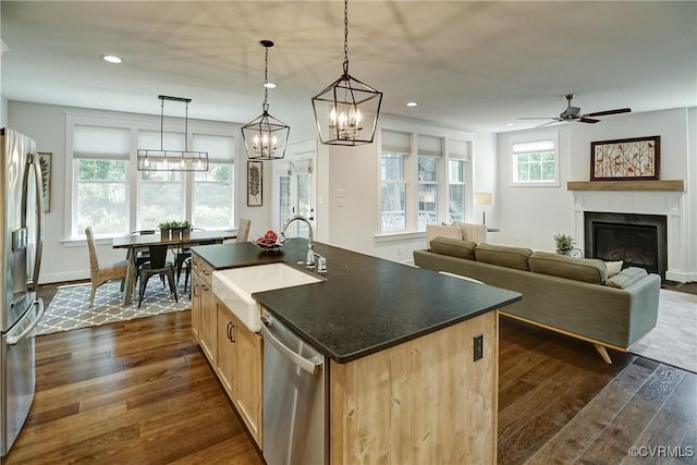 2500 Madison Station Ct, Henrico, VA 23233 - kitchen featuring appliances with stainless steel finishes, dark wood-type flooring, a glass covered fireplace, a center island with sink, and recessed lighting
