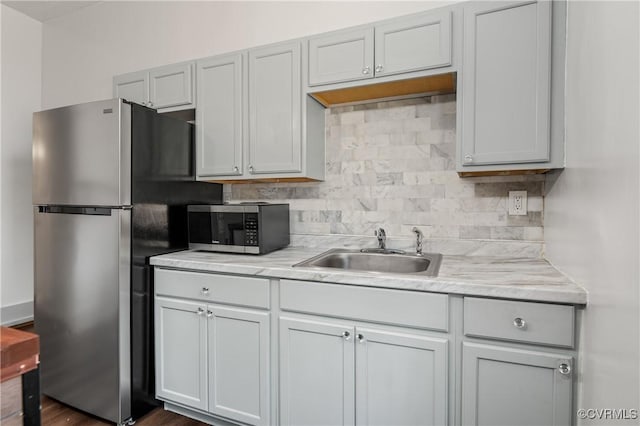 2909 Hull St, Richmond, VA 23224 - kitchen with stainless steel appliances, light countertops, and backsplash