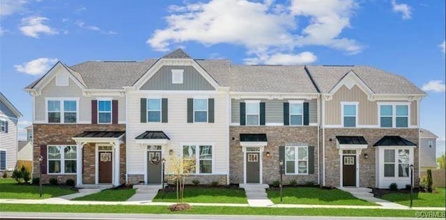 2211 Palm Ct, Sandston, VA 23150 - view of property featuring board and batten siding, a front yard, and stone siding
