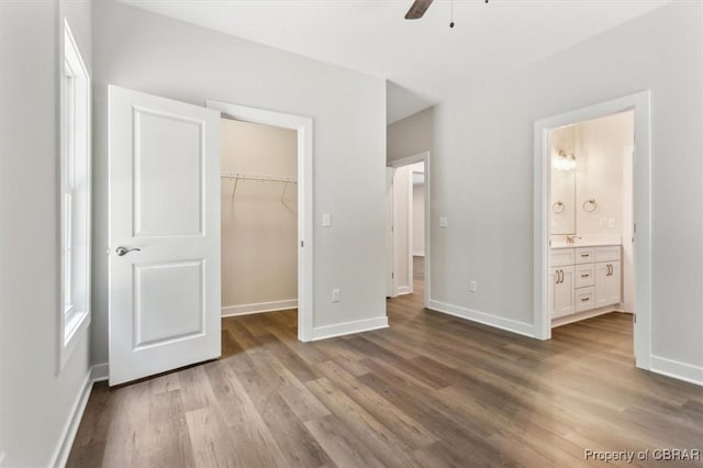 5883 Mill Race Pl, Gloucester, VA 23061 - unfurnished bedroom featuring wood finished floors, a spacious closet, a closet, connected bathroom, and a ceiling fan