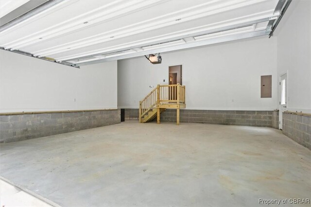 5883 Mill Race Pl, Gloucester, VA 23061 - garage with electric panel, a garage door opener, and concrete block wall