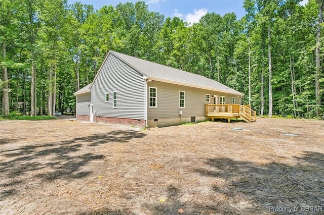 5883 Mill Race Pl, Gloucester, VA 23061 - view of side of home with crawl space, a wooden deck, and a forest view