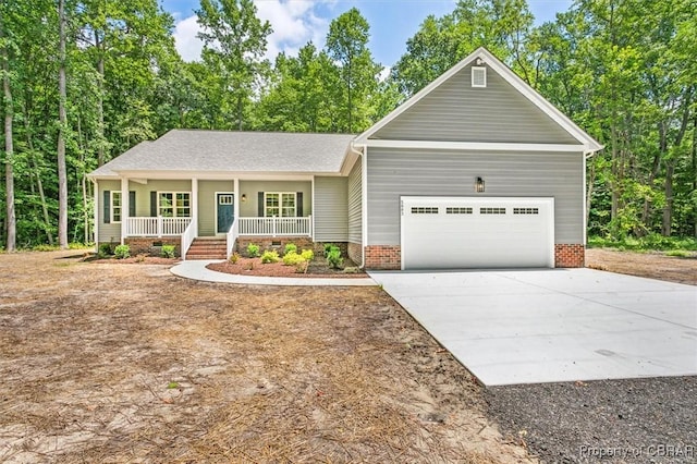 5883 Mill Race Pl, Gloucester, VA 23061 - view of front of property with a porch, a garage, and concrete driveway