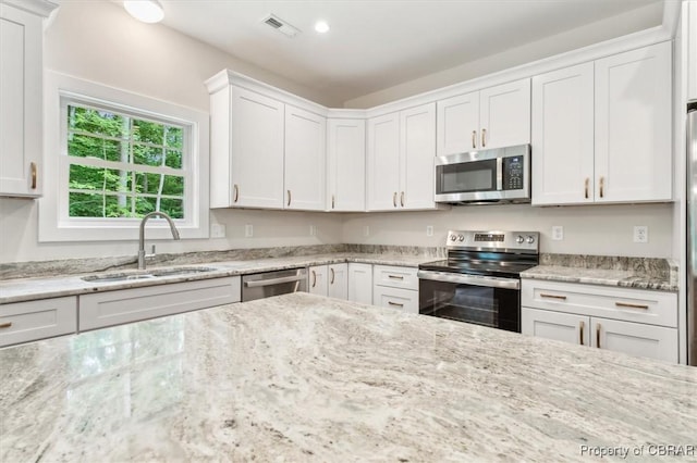 5883 Mill Race Pl, Gloucester, VA 23061 - kitchen featuring stainless steel appliances, white cabinetry, light stone countertops, and recessed lighting