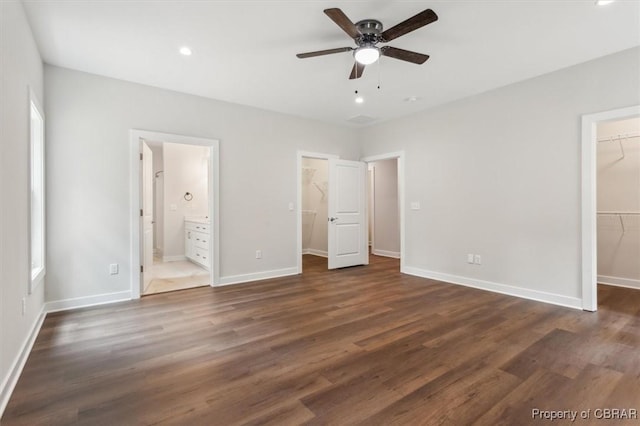 5883 Mill Race Pl, Gloucester, VA 23061 - unfurnished bedroom featuring a walk in closet, a closet, dark wood-type flooring, connected bathroom, and recessed lighting