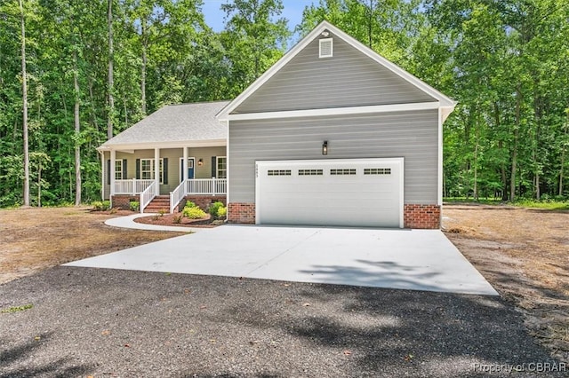 5883 Mill Race Pl, Gloucester, VA 23061 - view of front of home with covered porch, an attached garage, and driveway