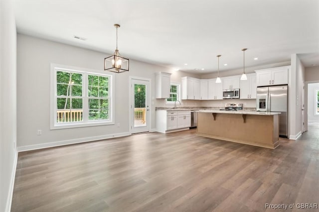5883 Mill Race Pl, Gloucester, VA 23061 - kitchen with appliances with stainless steel finishes, white cabinets, healthy amount of natural light, recessed lighting, and wood finished floors