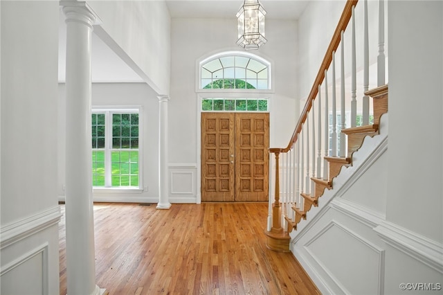 3007 Tranbycroft Way, Sandy Hook, VA 23153 - entryway with healthy amount of natural light, light wood finished floors, stairs, a decorative wall, and a high ceiling