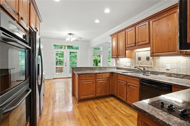 3007 Tranbycroft Way, Sandy Hook, VA 23153 - kitchen featuring black appliances, brown cabinetry, a peninsula, ornamental molding, and recessed lighting