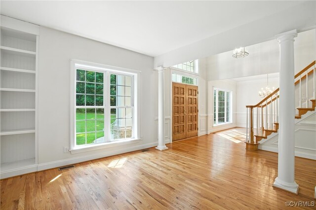 3007 Tranbycroft Way, Sandy Hook, VA 23153 - entrance foyer with decorative columns, wood finished floors, stairs, and a chandelier