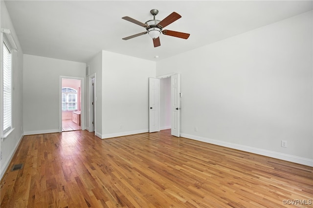 3007 Tranbycroft Way, Sandy Hook, VA 23153 - unfurnished bedroom featuring light wood finished floors, multiple windows, ensuite bath, and ceiling fan