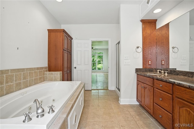 3007 Tranbycroft Way, Sandy Hook, VA 23153 - bathroom featuring vanity, a whirlpool tub, and tile patterned flooring