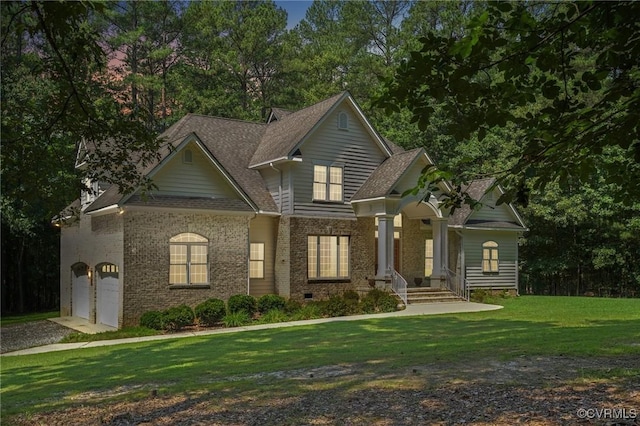 3007 Tranbycroft Way, Sandy Hook, VA 23153 - view of front of property with brick siding, a garage, driveway, and a front lawn