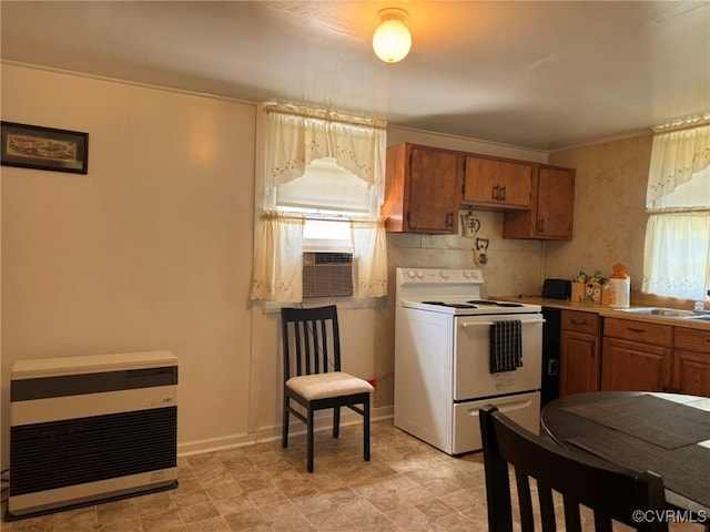875 Islington Rd, Warsaw, VA 22572 - kitchen with white electric stove, brown cabinets, heating unit, cooling unit, and light countertops