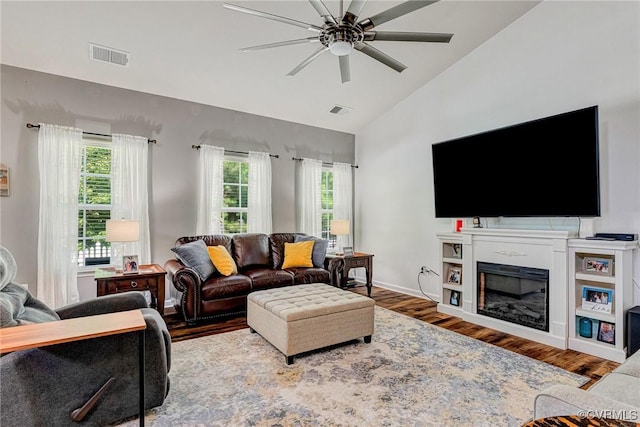 5858 Pilmour Dr, Providence Forge, VA 23140 - living area with healthy amount of natural light, wood finished floors, ceiling fan, a fireplace, and high vaulted ceiling