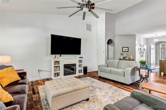 5858 Pilmour Dr, Providence Forge, VA 23140 - living area with arched walkways, ceiling fan, high vaulted ceiling, wood finished floors, and a glass covered fireplace