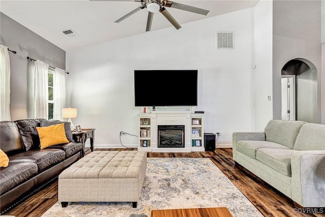5858 Pilmour Dr, Providence Forge, VA 23140 - living room featuring ceiling fan, arched walkways, wood finished floors, a glass covered fireplace, and vaulted ceiling