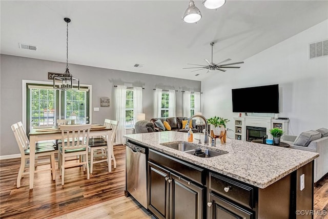 5858 Pilmour Dr, Providence Forge, VA 23140 - kitchen with stainless steel dishwasher, open floor plan, light wood-style floors, ceiling fan, and decorative light fixtures