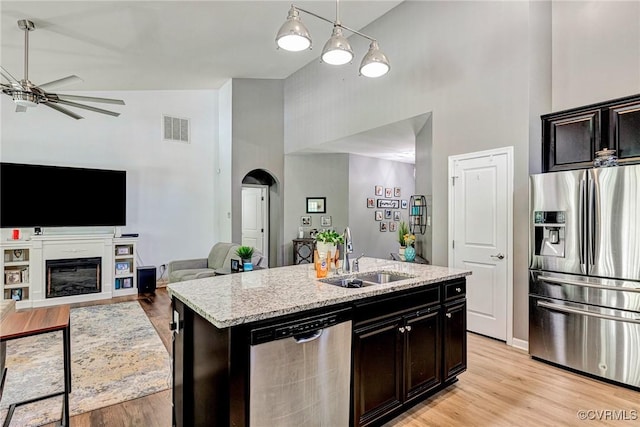 5858 Pilmour Dr, Providence Forge, VA 23140 - kitchen featuring appliances with stainless steel finishes, high vaulted ceiling, ceiling fan, light stone counters, and a kitchen island with sink