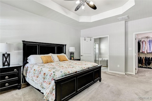 5858 Pilmour Dr, Providence Forge, VA 23140 - bedroom featuring light carpet, a tray ceiling, a spacious closet, ensuite bath, and a closet