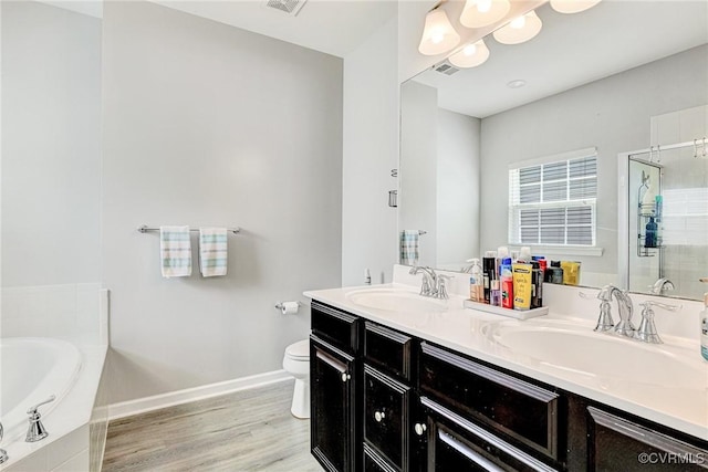5858 Pilmour Dr, Providence Forge, VA 23140 - full bathroom featuring double vanity, a bath, a stall shower, wood finished floors, and a chandelier
