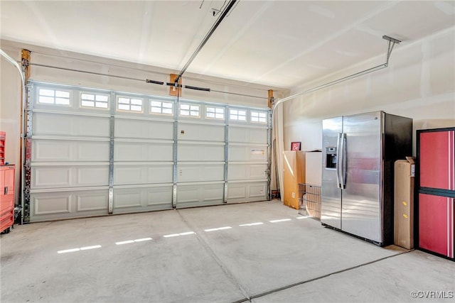 5858 Pilmour Dr, Providence Forge, VA 23140 - garage featuring stainless steel fridge and a garage door opener