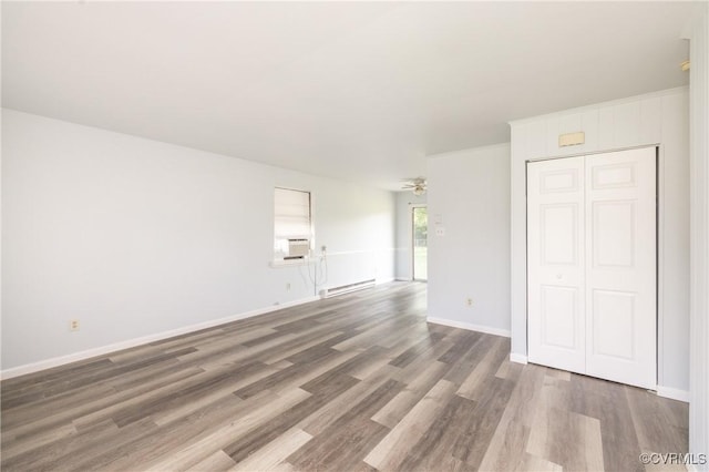 3317 Gaulding Ln, Richmond, VA 23223 - unfurnished living room featuring baseboard heating, wood finished floors, ceiling fan, and cooling unit