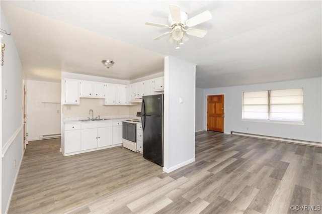 3317 Gaulding Ln, Richmond, VA 23223 - kitchen featuring a baseboard radiator, freestanding refrigerator, electric stove, open floor plan, and light countertops