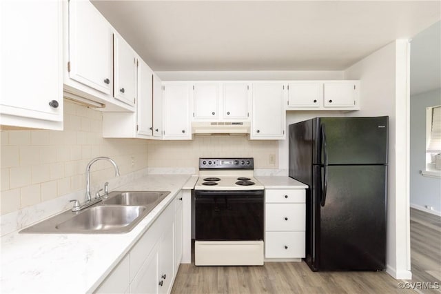 3317 Gaulding Ln, Richmond, VA 23223 - kitchen featuring freestanding refrigerator, electric stove, under cabinet range hood, and light wood finished floors