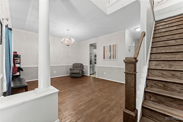 5129 Jenkins Forest Ln, Sandston, VA 23150 - unfurnished living room featuring stairs, decorative columns, crown molding, wood finished floors, and a chandelier