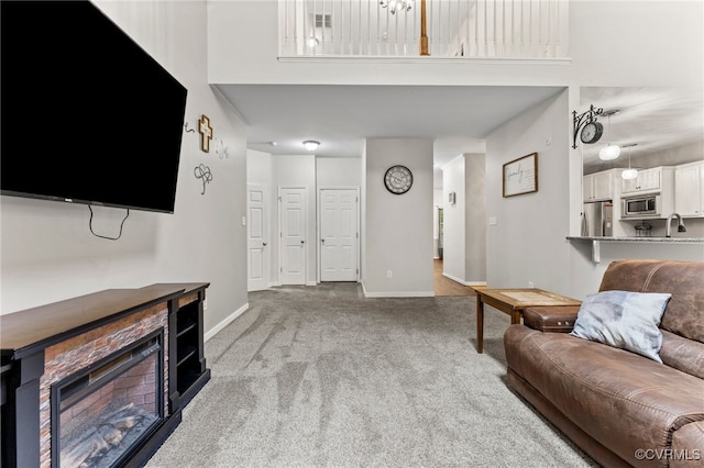 5129 Jenkins Forest Ln, Sandston, VA 23150 - carpeted living area with a towering ceiling and a fireplace