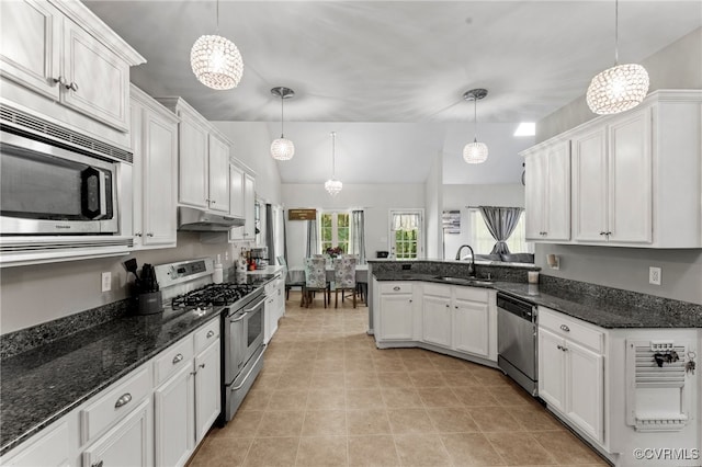 5129 Jenkins Forest Ln, Sandston, VA 23150 - kitchen with stainless steel appliances, under cabinet range hood, white cabinetry, a peninsula, and vaulted ceiling