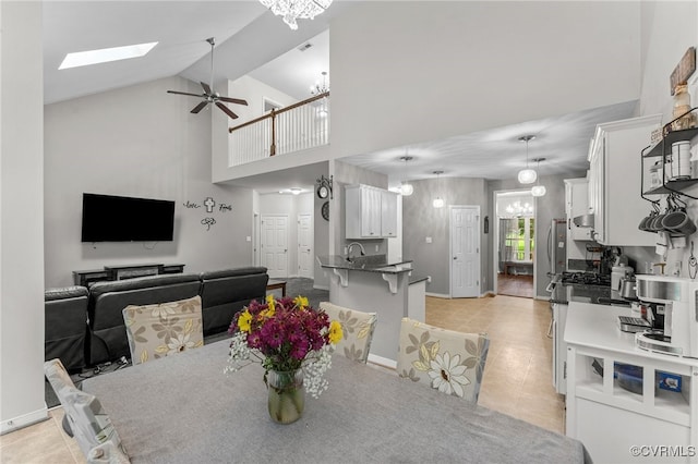 5129 Jenkins Forest Ln, Sandston, VA 23150 - dining area featuring a chandelier, ceiling fan, high vaulted ceiling, light tile patterned floors, and a skylight