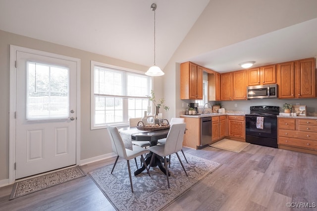 1014 Pennsylvania Ave, Glen Allen, VA 23060 - kitchen with appliances with stainless steel finishes, light countertops, light wood-style flooring, hanging light fixtures, and brown cabinets
