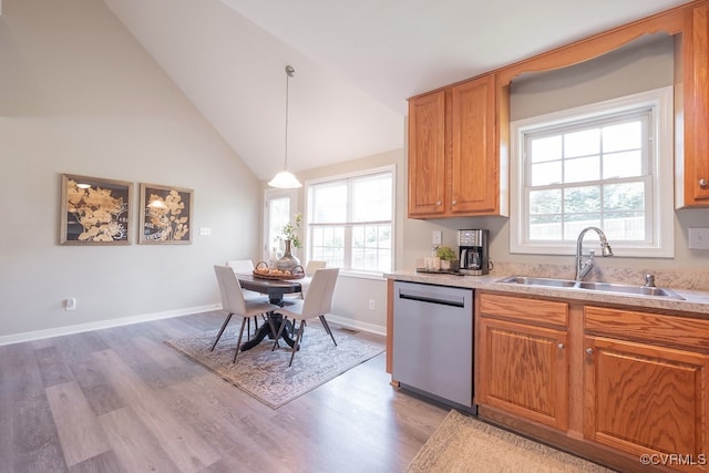 1014 Pennsylvania Ave, Glen Allen, VA 23060 - kitchen featuring stainless steel dishwasher, light wood-style flooring, plenty of natural light, light countertops, and vaulted ceiling
