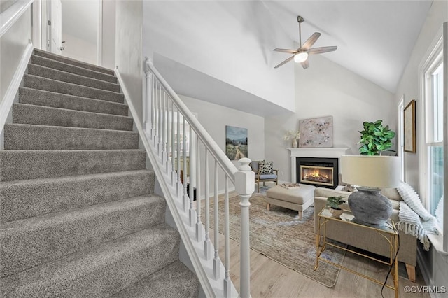1900 Pine Creek Bluff Ct, Powhatan, VA 23139 - stairs featuring wood finished floors, a ceiling fan, high vaulted ceiling, and a glass covered fireplace