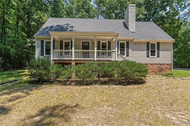1900 Pine Creek Bluff Ct, Powhatan, VA 23139 - view of front of home with a front lawn, a chimney, covered porch, and roof with shingles