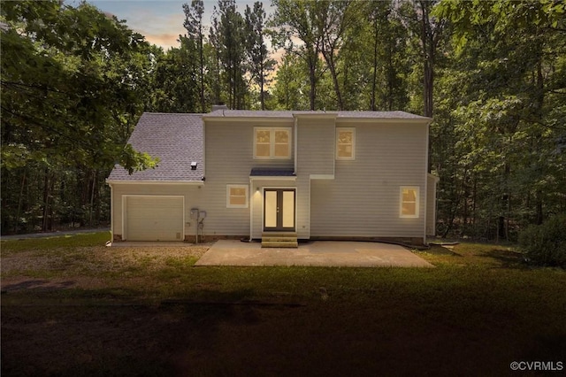1900 Pine Creek Bluff Ct, Powhatan, VA 23139 - back of property at dusk featuring driveway, french doors, entry steps, a patio area, and a lawn