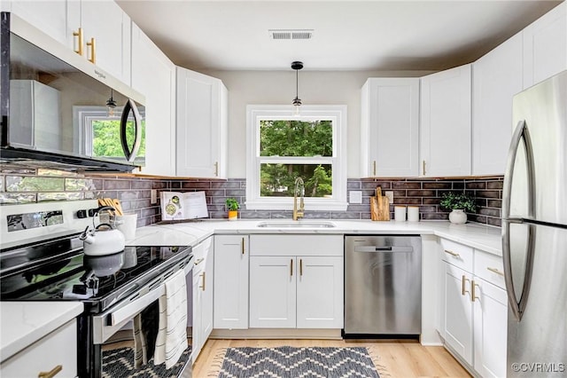 6910 Siliman Dr, Chesterfield, VA 23832 - kitchen with appliances with stainless steel finishes, plenty of natural light, and white cabinets