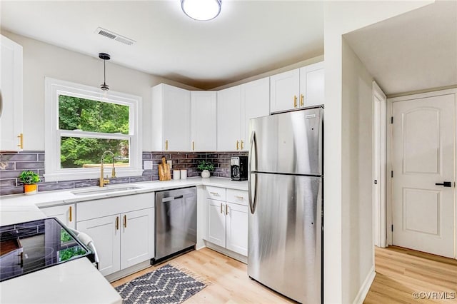 6910 Siliman Dr, Chesterfield, VA 23832 - kitchen with stainless steel appliances, light wood-type flooring, light countertops, and white cabinetry