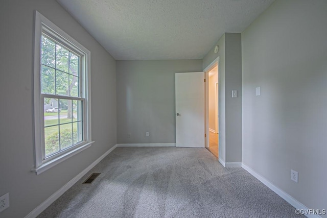 1300 Hyner Cir, Sandston, VA 23231 - unfurnished bedroom with a textured ceiling, multiple windows, and carpet floors