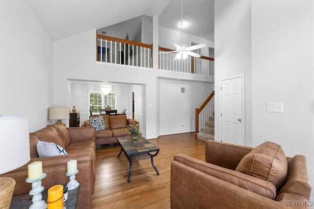 3019 Ramsey Dr, Chester, VA 23831 - living room featuring wood finished floors, high vaulted ceiling, stairs, and a ceiling fan