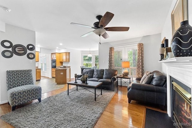 3019 Ramsey Dr, Chester, VA 23831 - living room with ceiling fan, light wood-style flooring, a glass covered fireplace, and recessed lighting