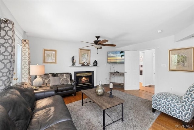3019 Ramsey Dr, Chester, VA 23831 - living area featuring a ceiling fan, wood finished floors, and a lit fireplace