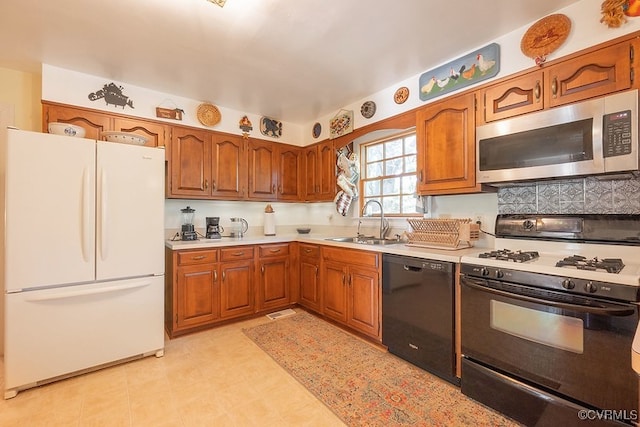 570 Three Chopt Rd, Manakin Sabot, VA 23103 - kitchen featuring freestanding refrigerator, range with gas stovetop, stainless steel microwave, black dishwasher, and brown cabinetry