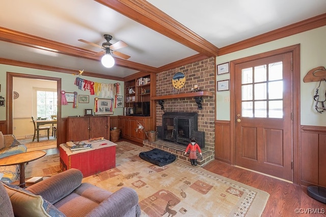 570 Three Chopt Rd, Manakin Sabot, VA 23103 - living area with ornamental molding, wood finished floors, a wainscoted wall, a ceiling fan, and a fireplace