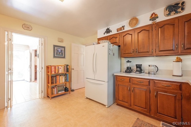 570 Three Chopt Rd, Manakin Sabot, VA 23103 - kitchen with freestanding refrigerator, brown cabinetry, light countertops, and light floors