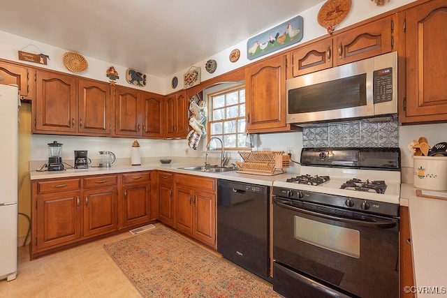 570 Three Chopt Rd, Manakin Sabot, VA 23103 - kitchen with stainless steel microwave, dishwasher, gas stove, light countertops, and freestanding refrigerator