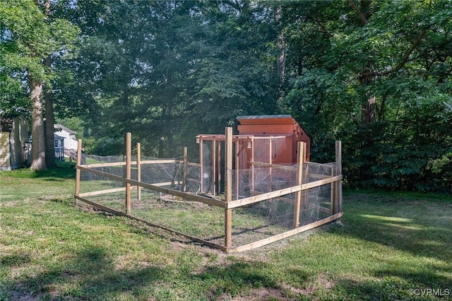 1203 Lemonwood Dr, North Prince George, VA 23860 - view of yard featuring exterior structure, a storage unit, and a view of trees